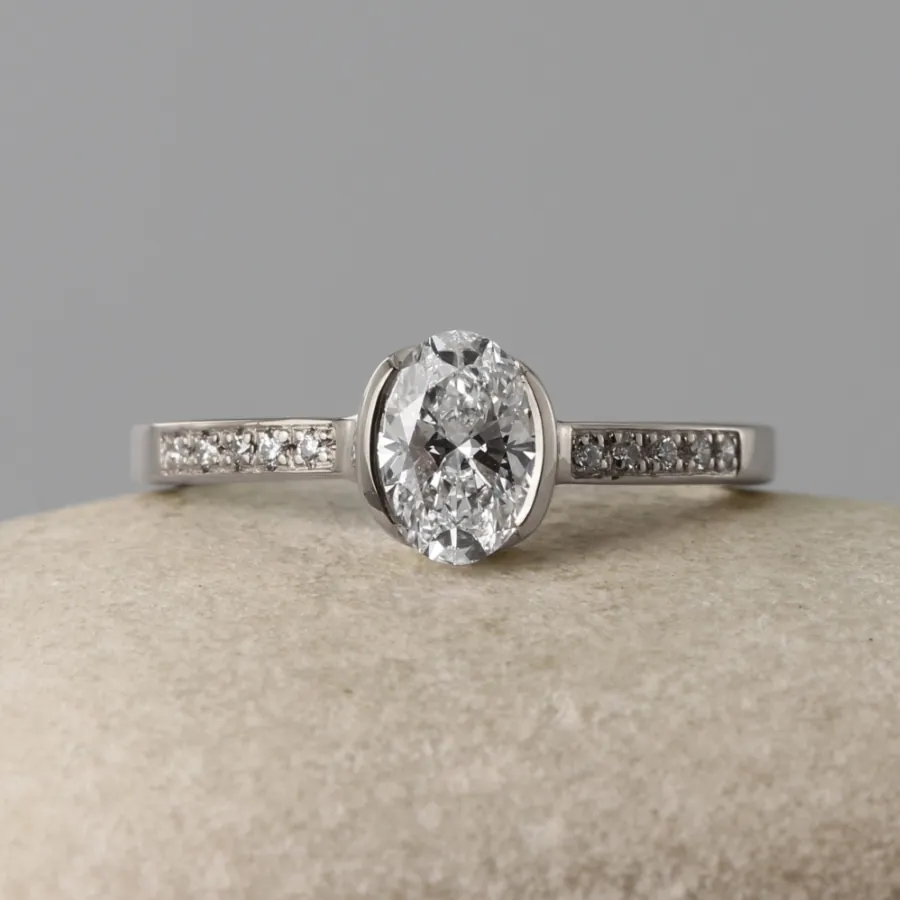 Sustainable Platinum Oval Solitaire Engagement Ring with Pave Shoulders